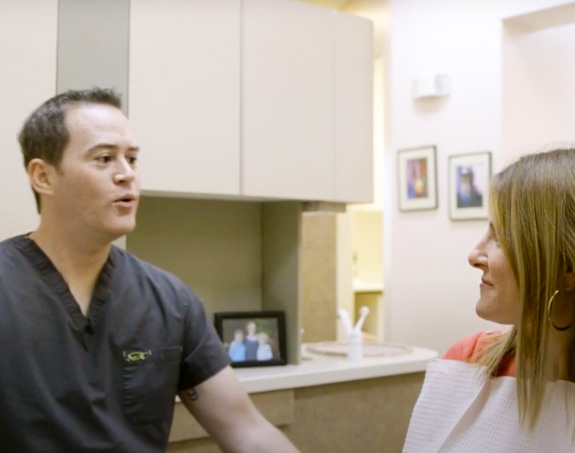 patient looking at her smile in the mirror